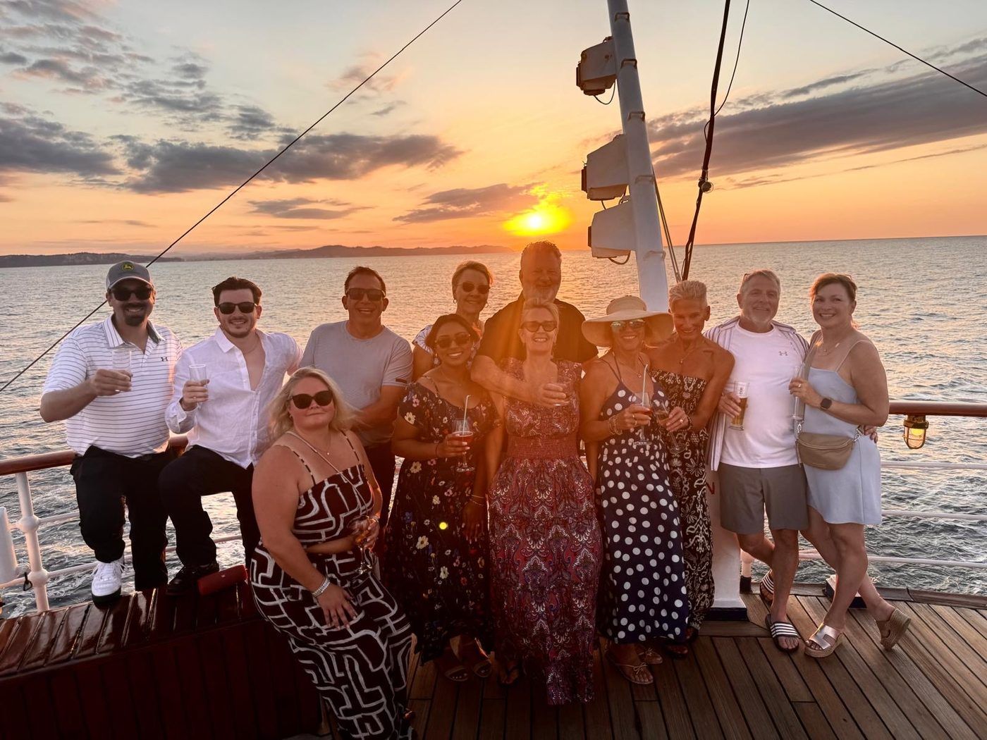 Founders together on a boat at sunset