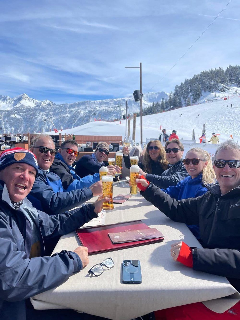 Founders toasting drinks on a mountainside after skiing