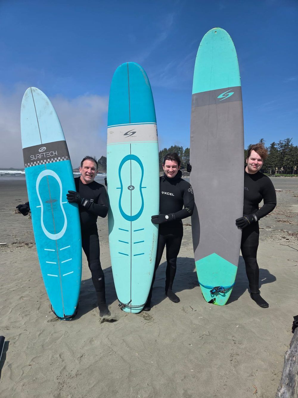 Founders with surfboards on the beach
