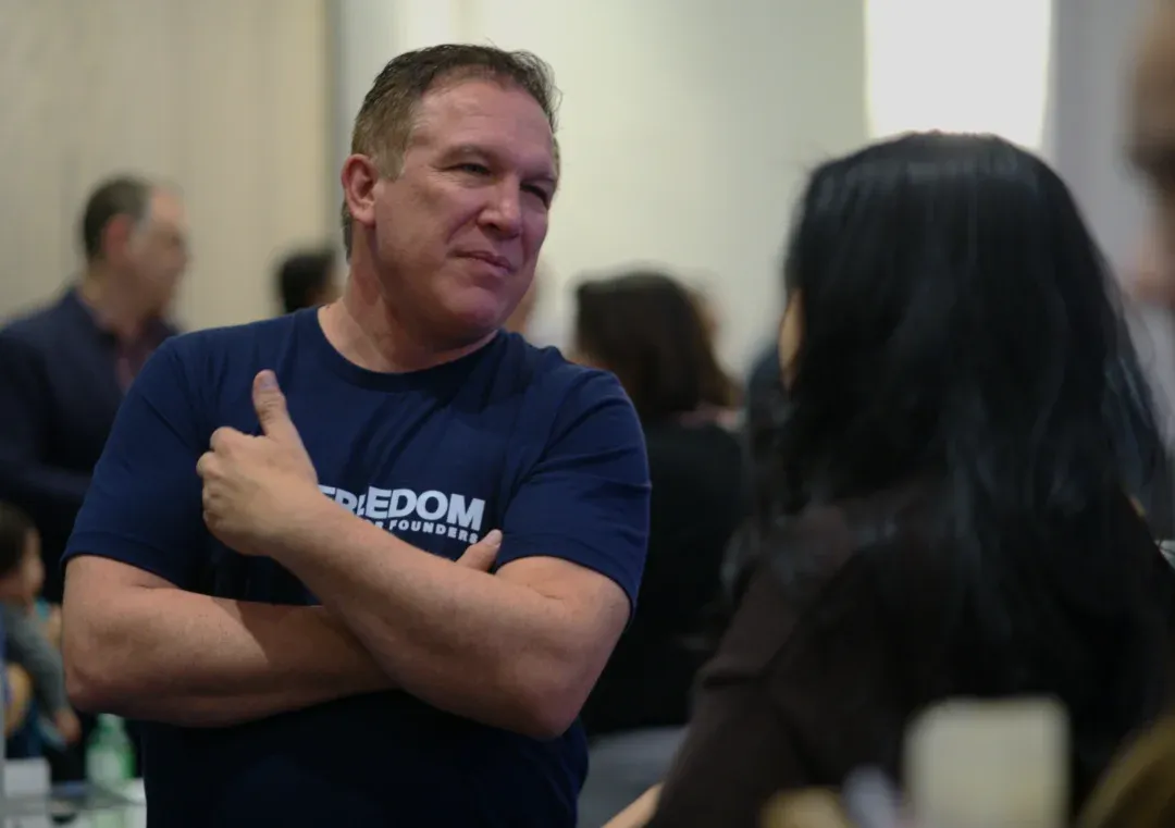 Simon listening to a business owner
