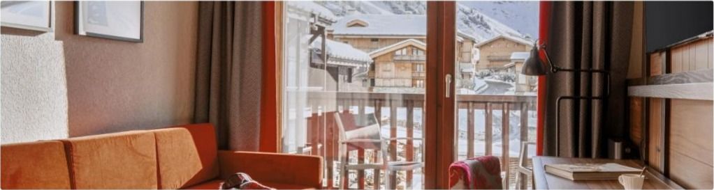 Suite lounge with balcony overlooking the village